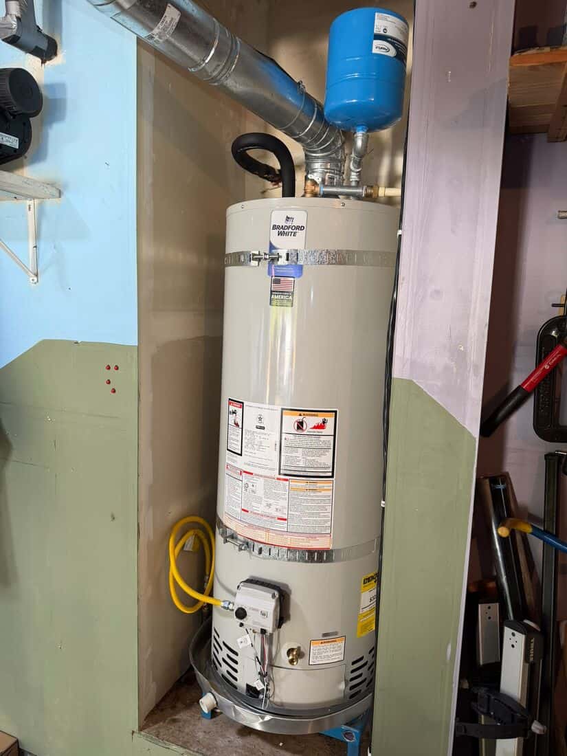Gas water heater installed in a closet with new venting, expansion tank, and gas flex connector